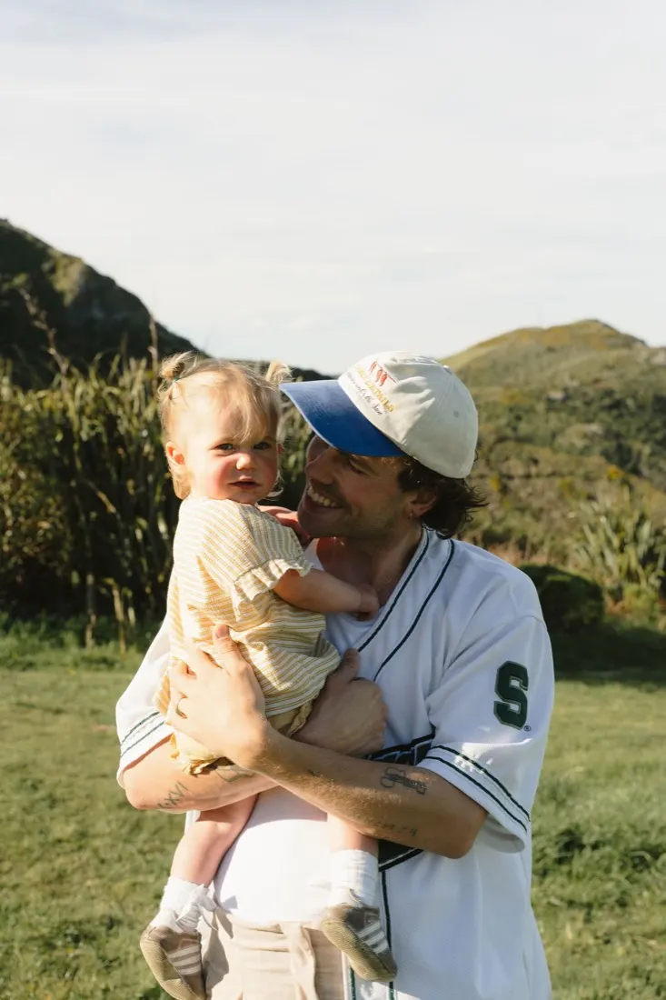 A father holding his young daughter on the Port Hills