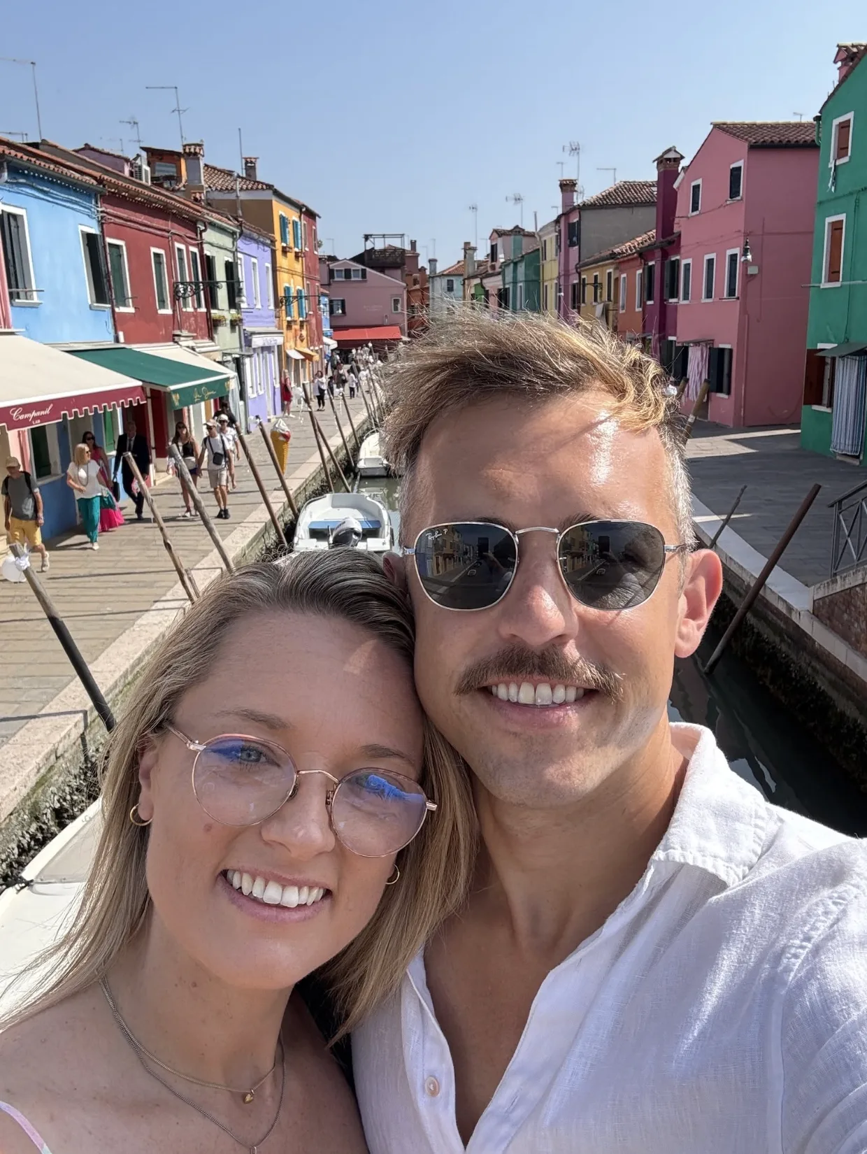 Simon Fox and his wife on a canal bridge in Burano, Italy